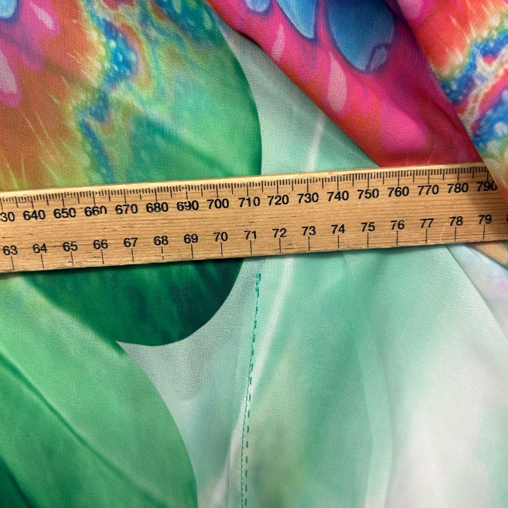 Colorful tie dye fabric detail view with measuring tape