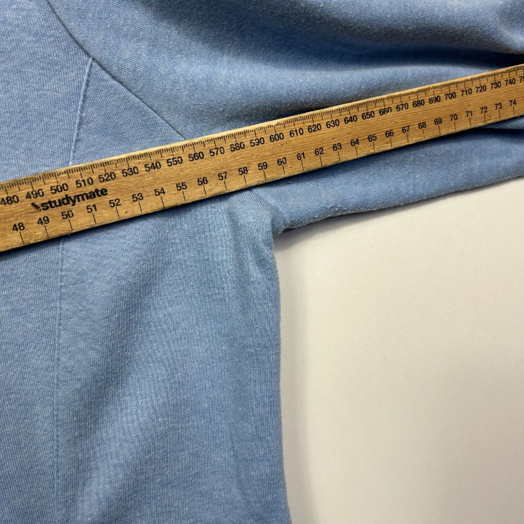 Blue fabric detail view with measuring tape