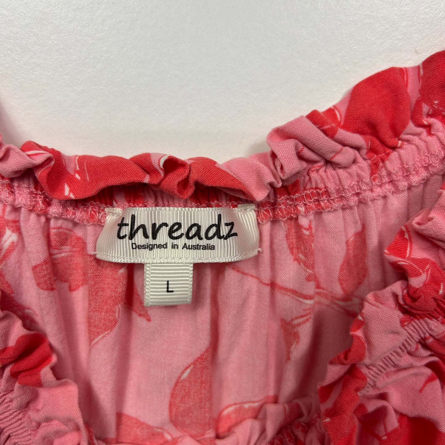 Pink floral top label detail view