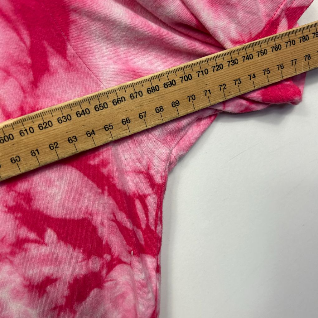 Pink tie dye fabric with measuring tape detail view