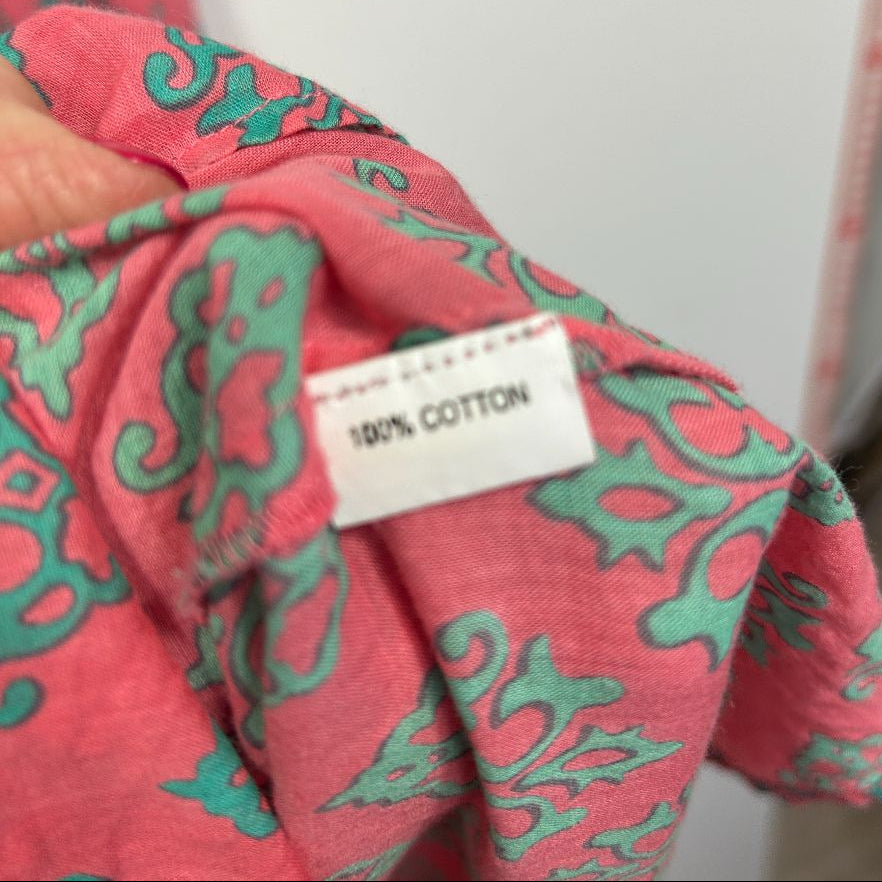 Red and green patterned cotton top detail view showing fabric label