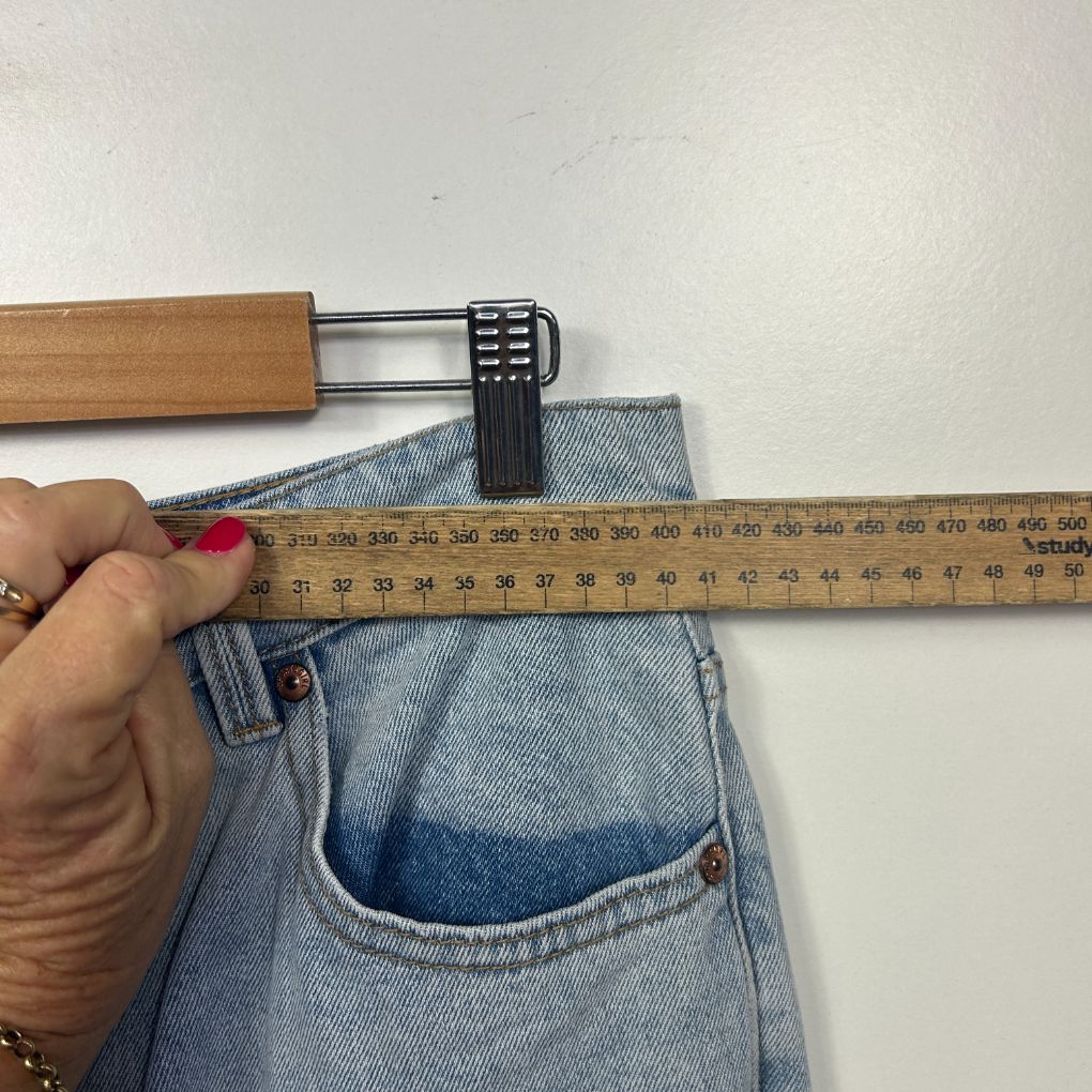 Light blue denim jeans front view with waist measurement