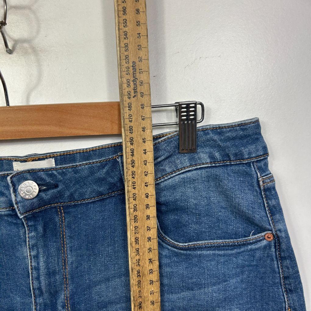 Blue denim jeans front view with measuring tape