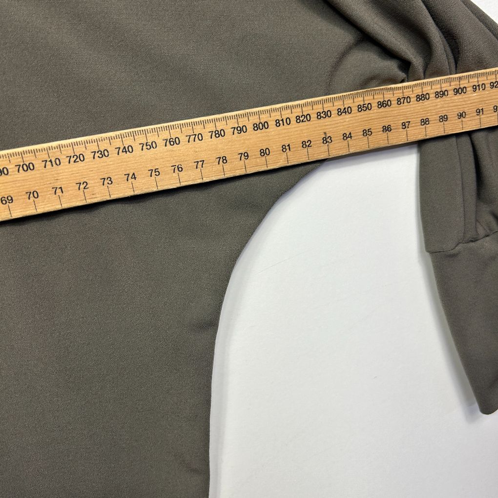 Olive green jacket side view with measuring tape