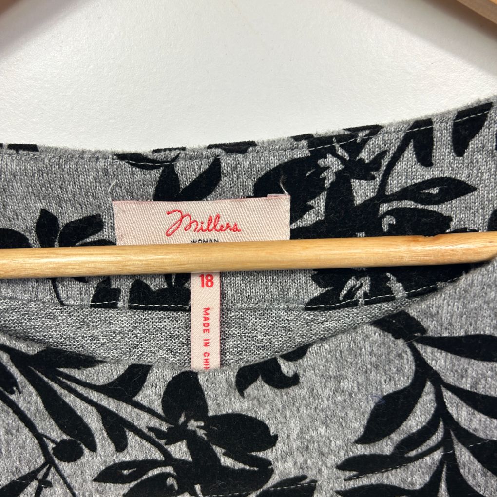 Grey and black floral knit top label detail view