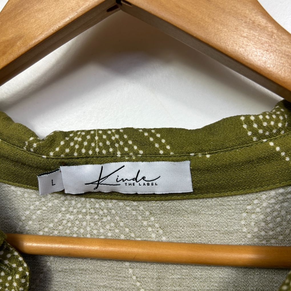 Green and cream knit sweater label detail view