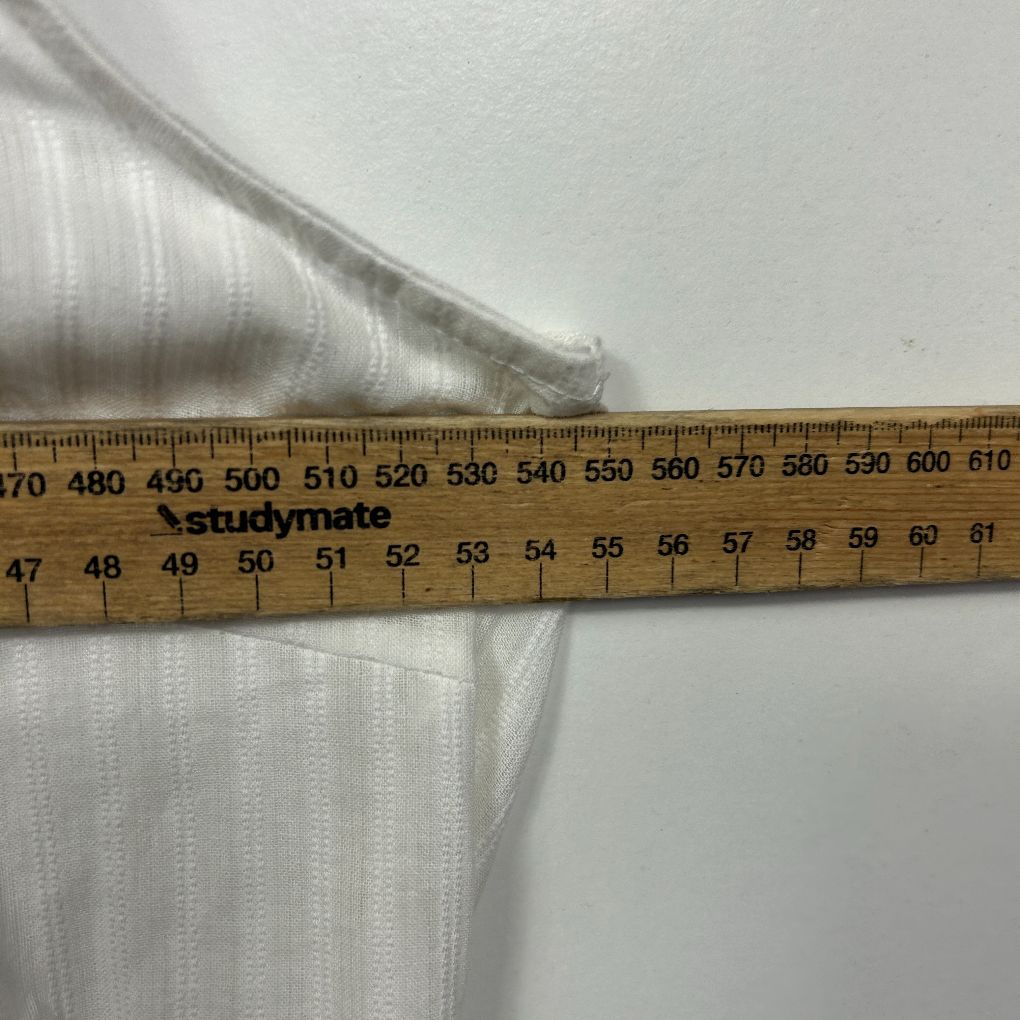 White ribbed fabric detail view with measurement ruler
