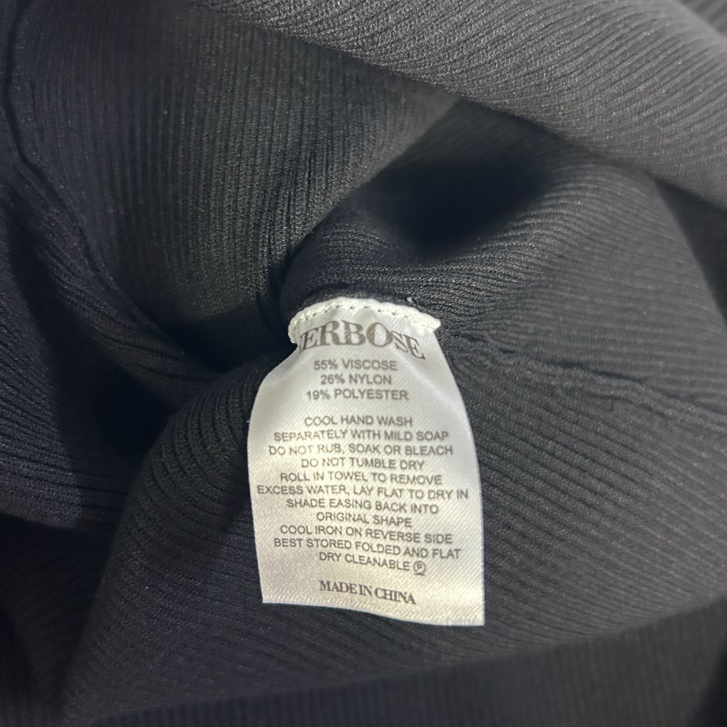 Black ribbed fabric detail view showing care label