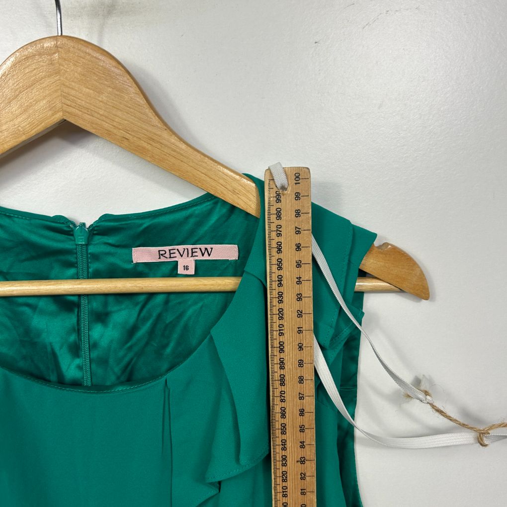 Green top front view on wooden hanger with measuring tape