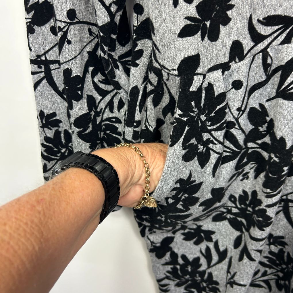 Grey and black floral print long sleeve top detail view