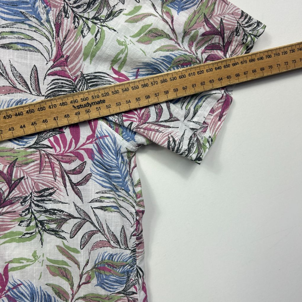 Multicoloured floral print fabric detail view with measuring tape