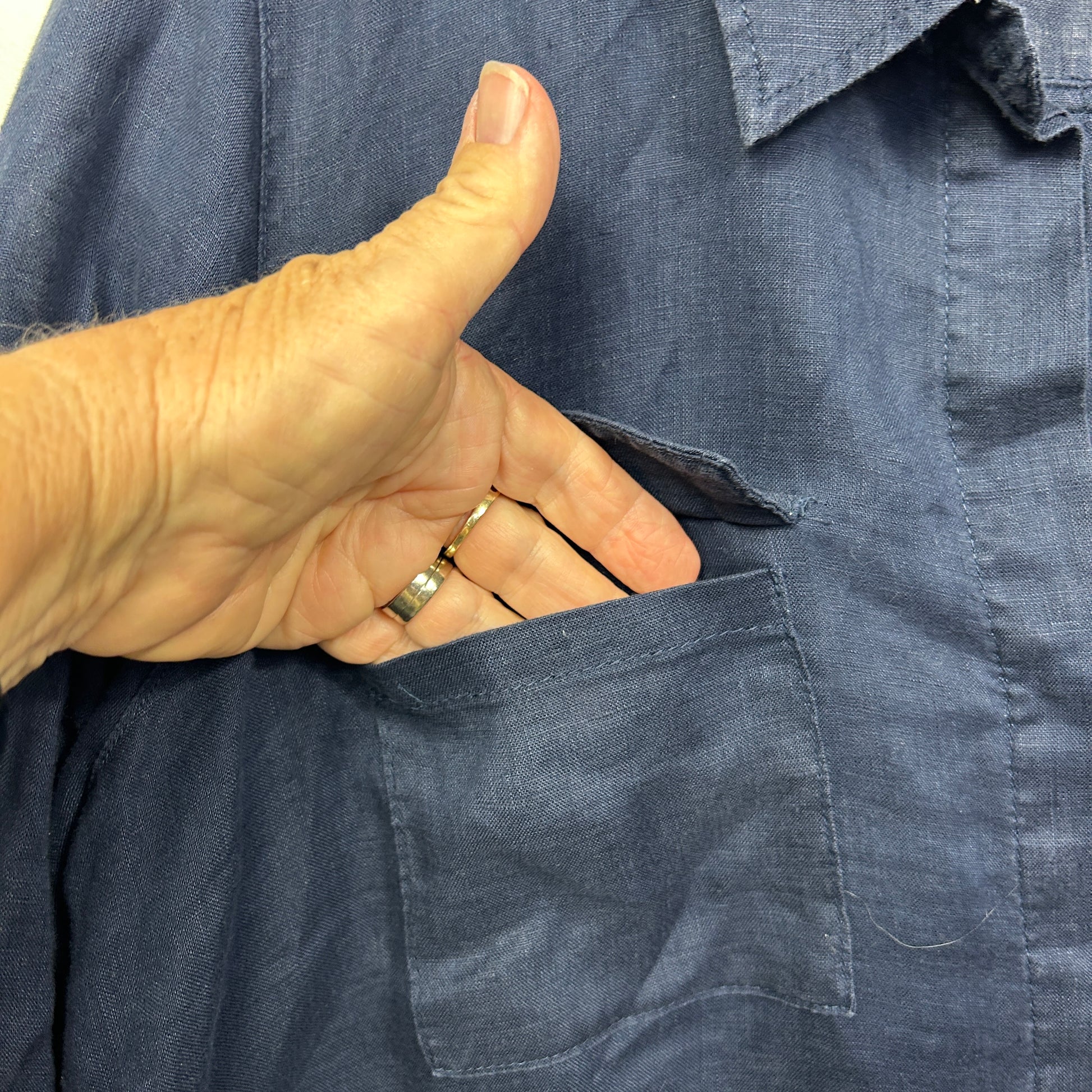 Grey shirt front view with hand in pocket