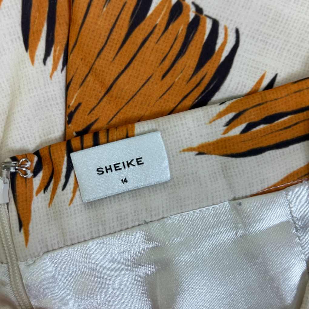 Orange and black striped shirt detail view showing label