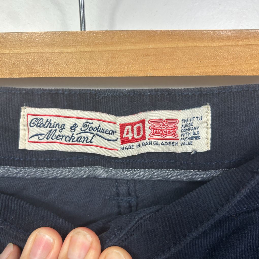 Navy ribbed trousers label detail view