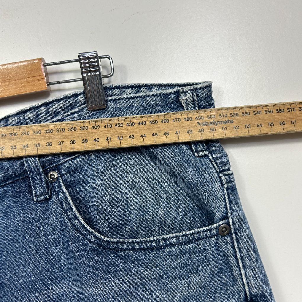 Blue denim jeans front view with measuring tape