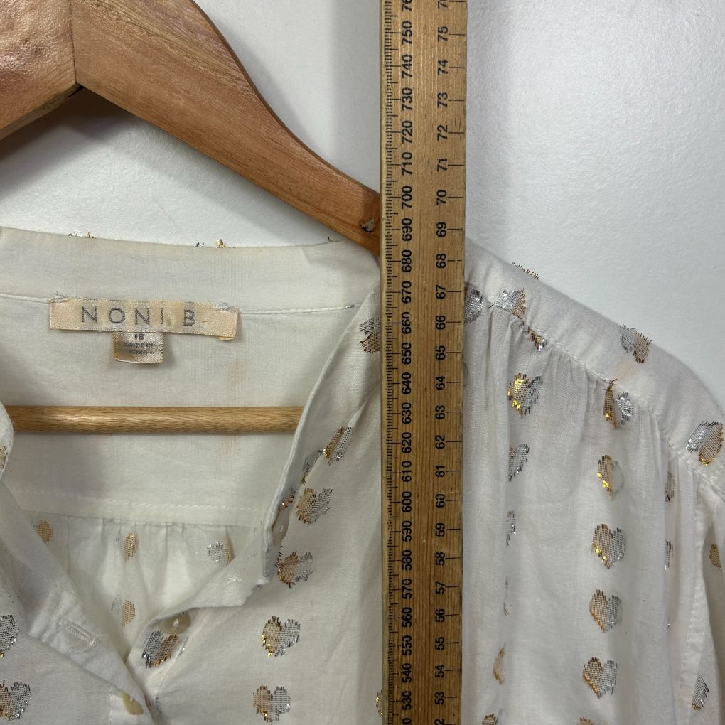 Cream blouse with brown floral pattern detail view