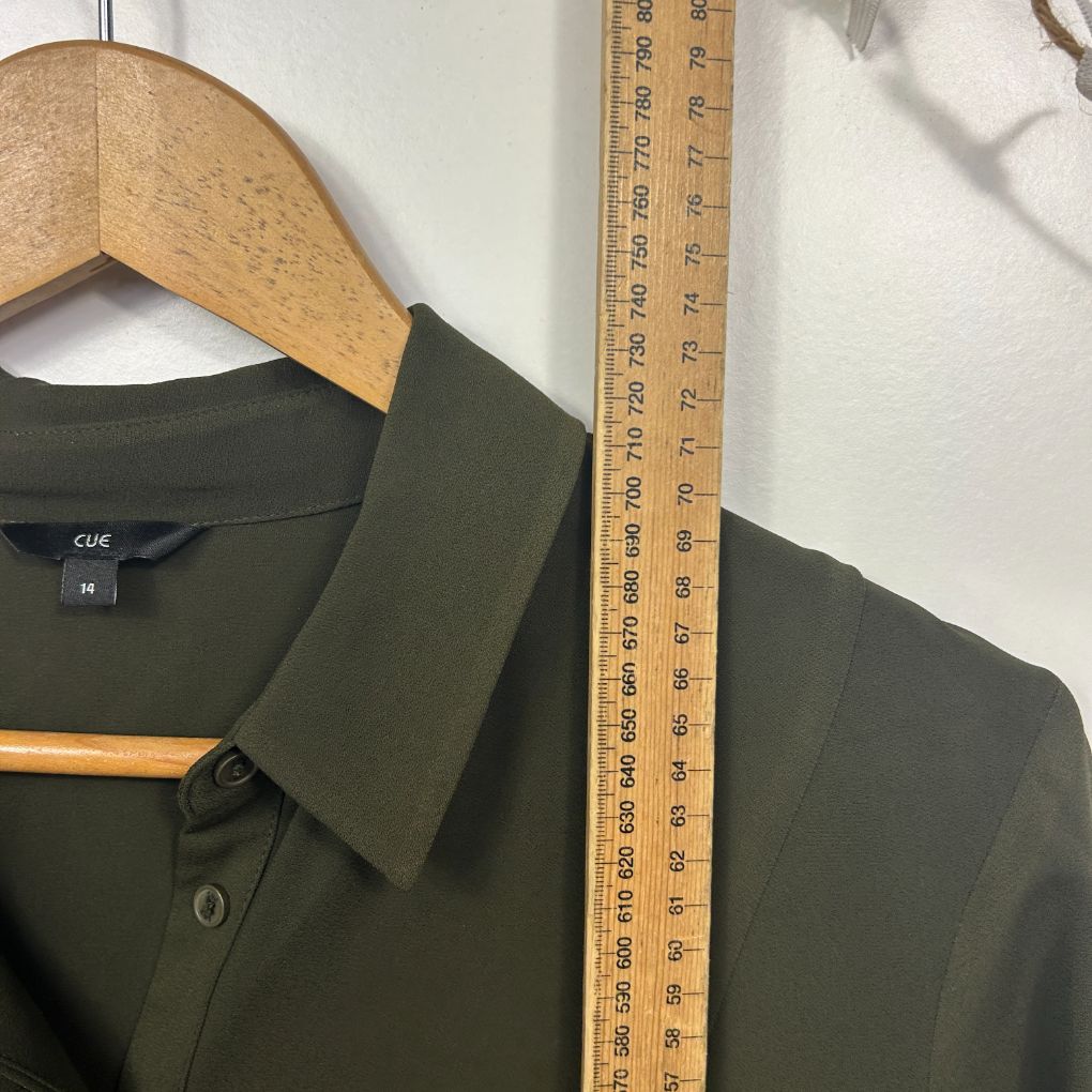 Olive green shirt front view on wooden hanger