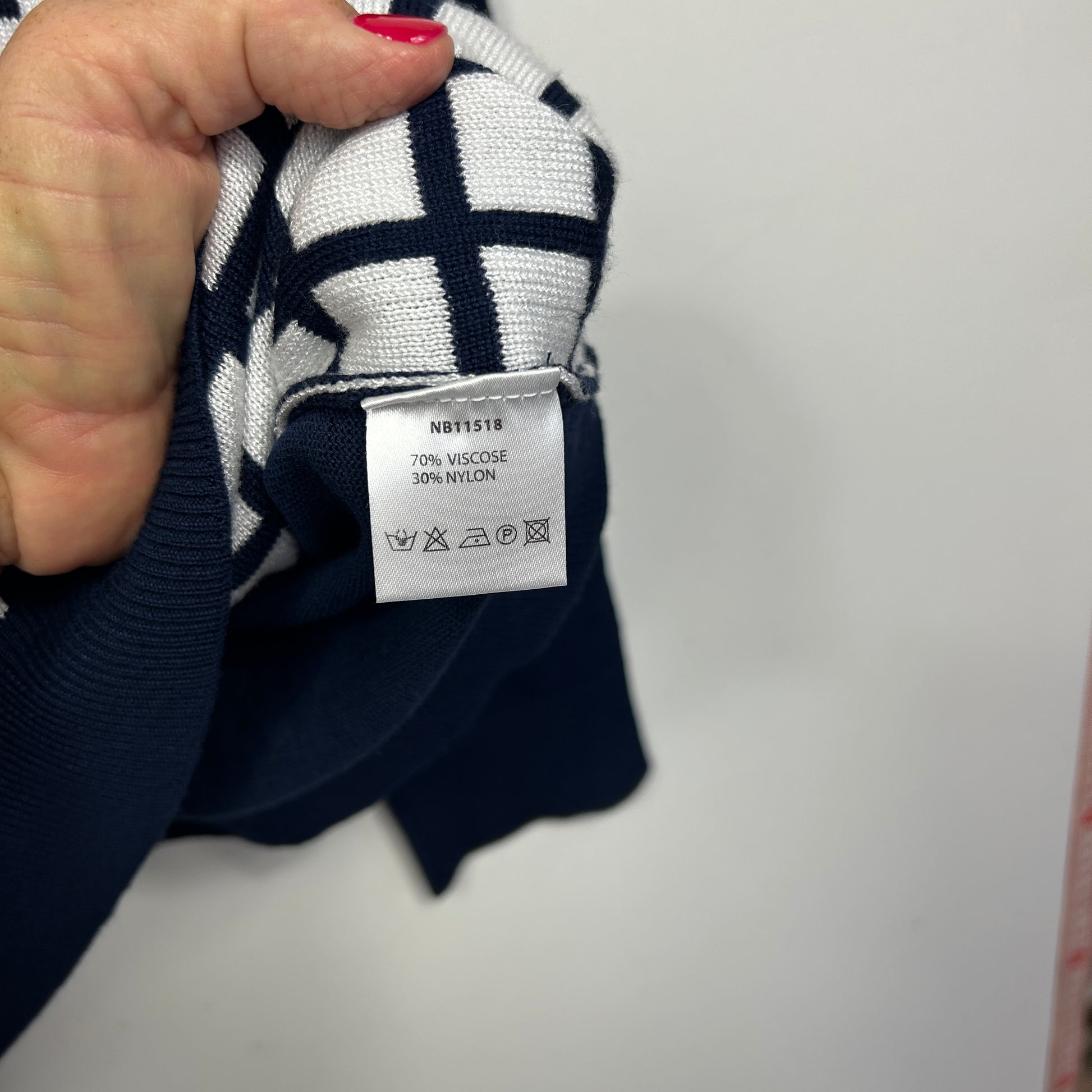 Navy and white striped sweater label detail view