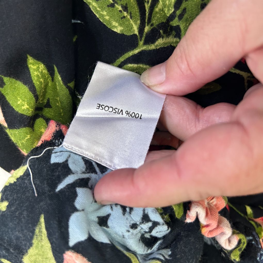 Black fabric with floral and leaf pattern detail view