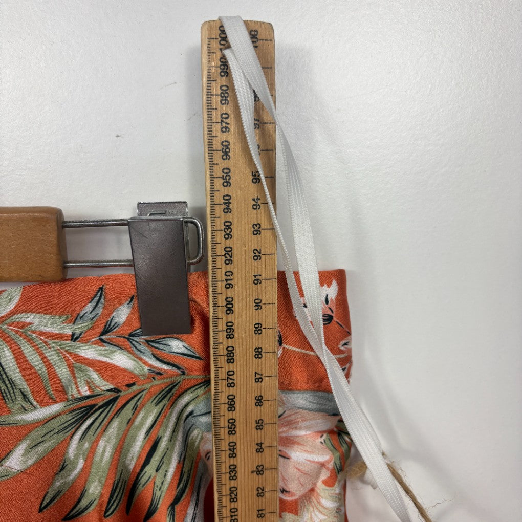 Orange floral fabric detail view with measuring ruler