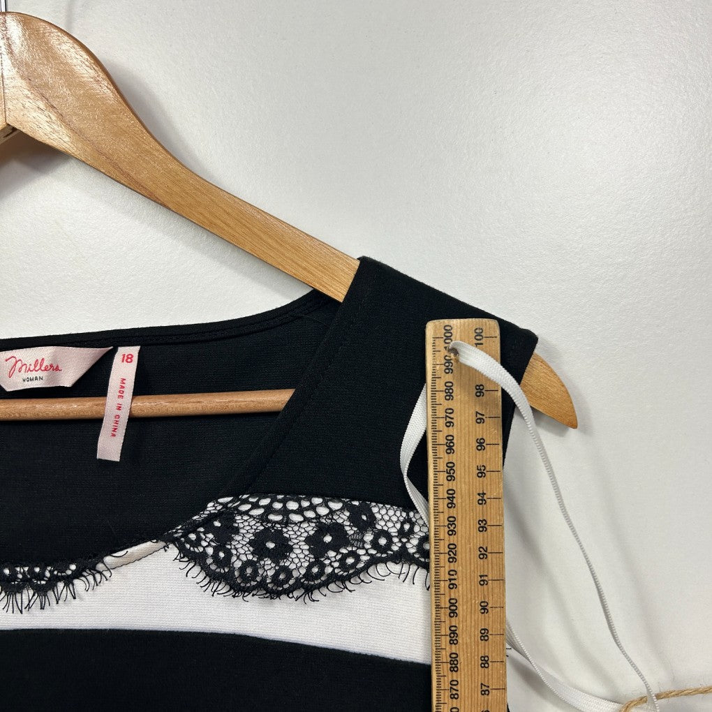 Black and white jumper front view with measuring tape