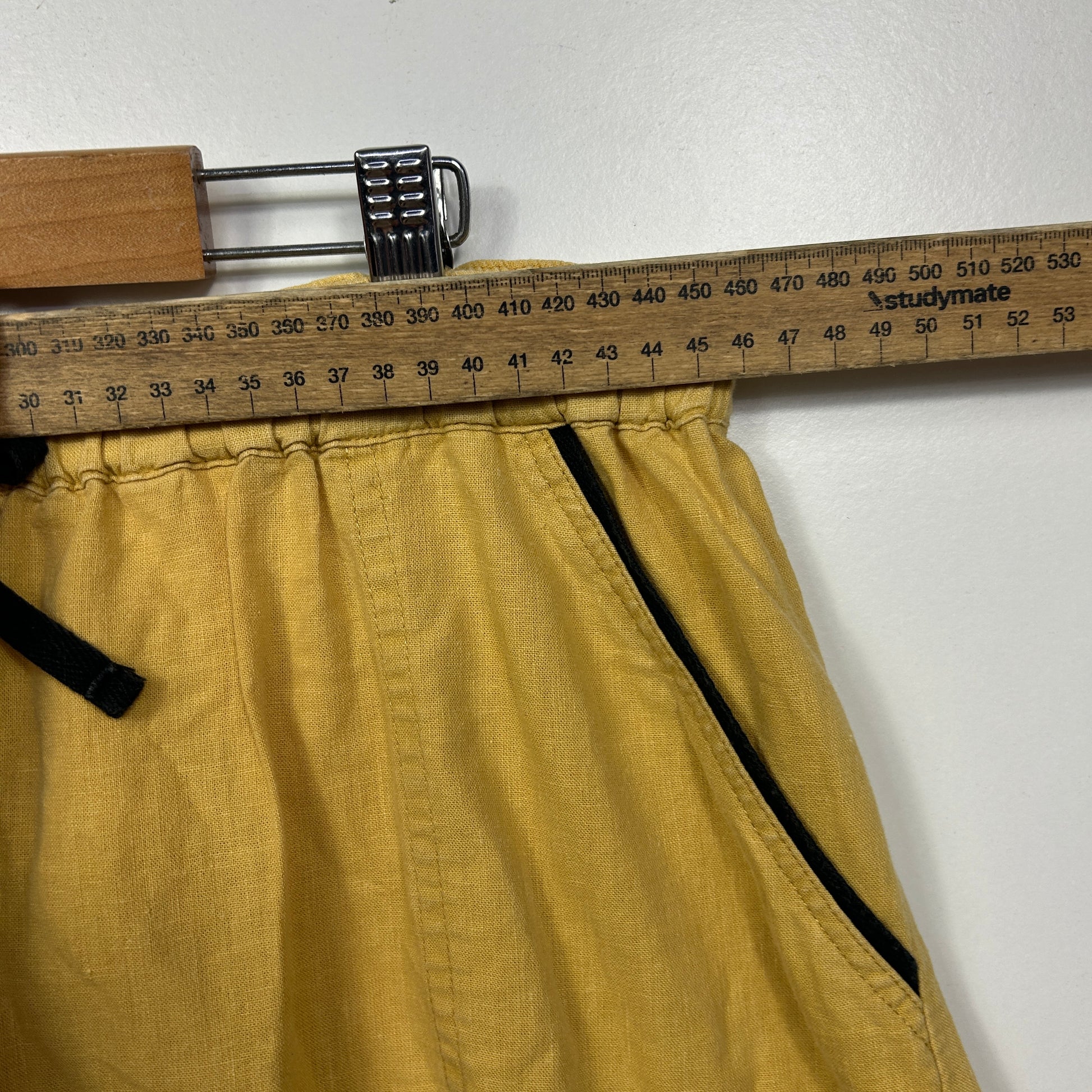 Yellow pants front view with measuring tape