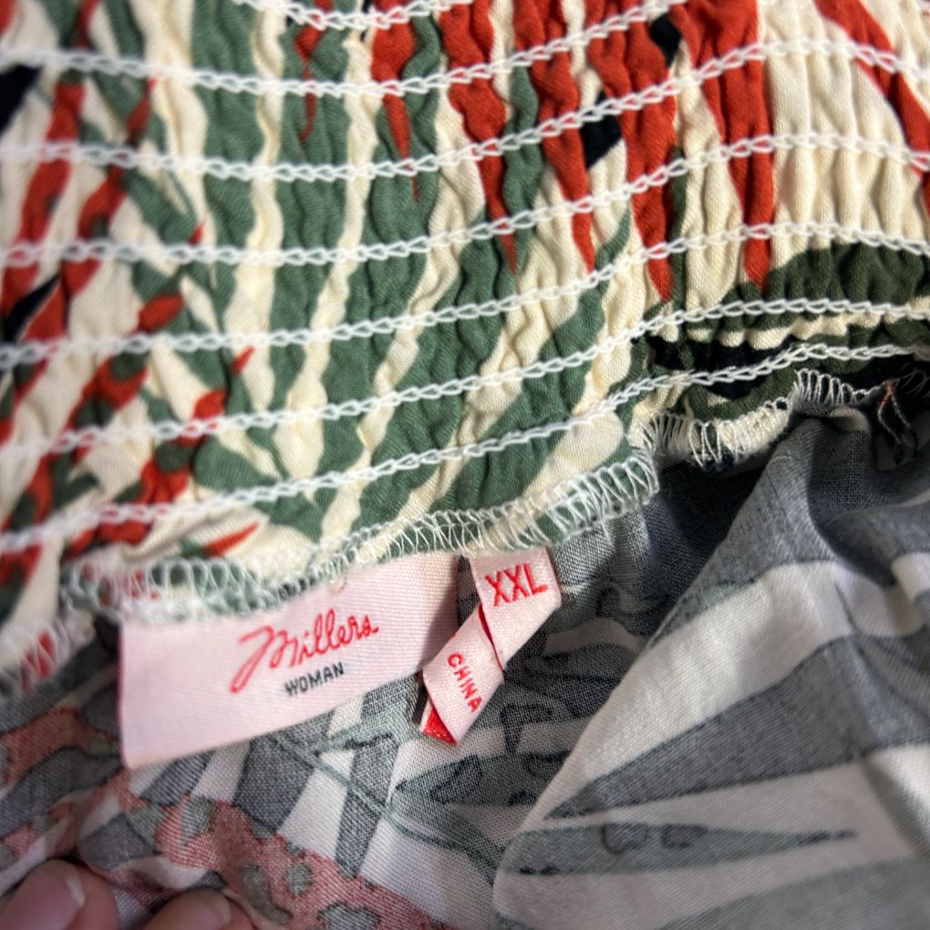 Patchwork quilt detail view with red green and cream fabric