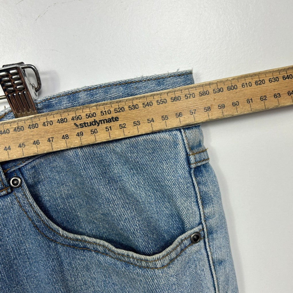 Light blue denim jeans front detail view with measuring tape