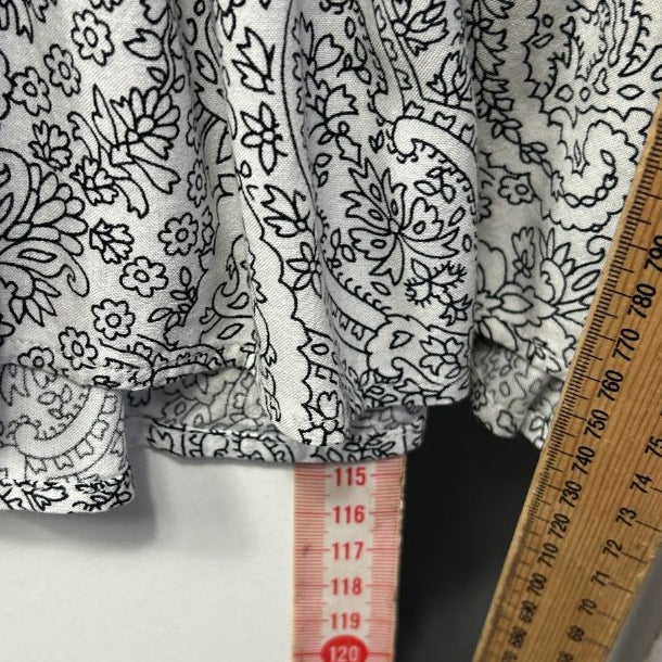 Black and white floral patterned fabric detail view with measuring tape