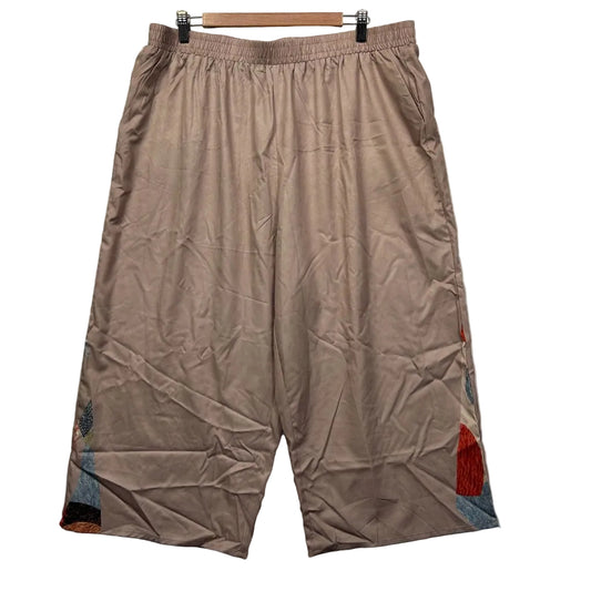 Beige cropped pants front view with graphic design detail