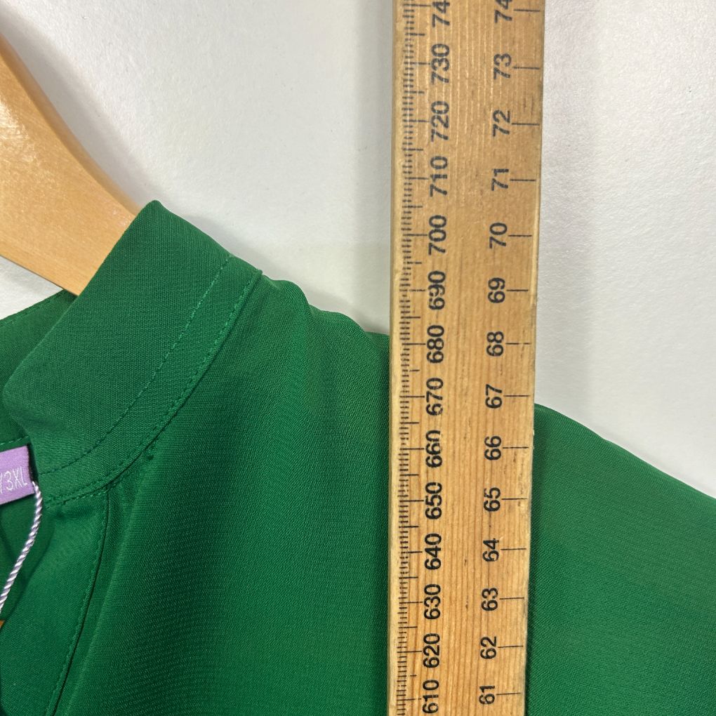 Green jumper detail view with measuring ruler