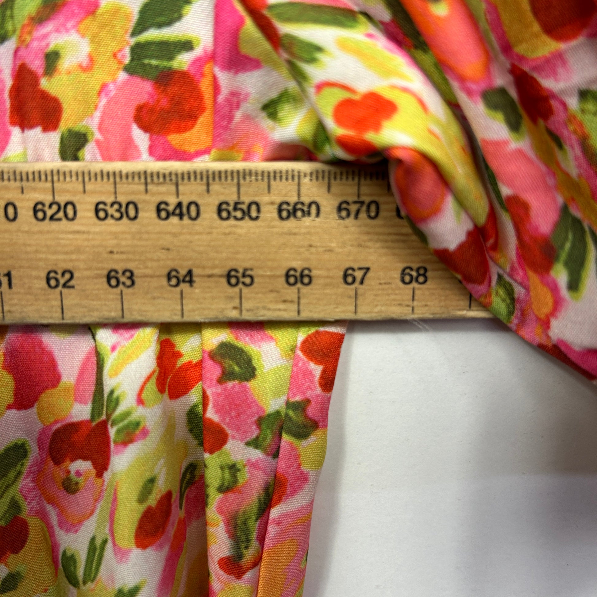 Colorful floral fabric detail view with ruler measurement