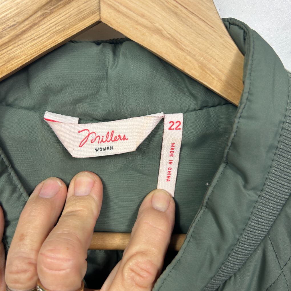 Sage green jacket label detail view