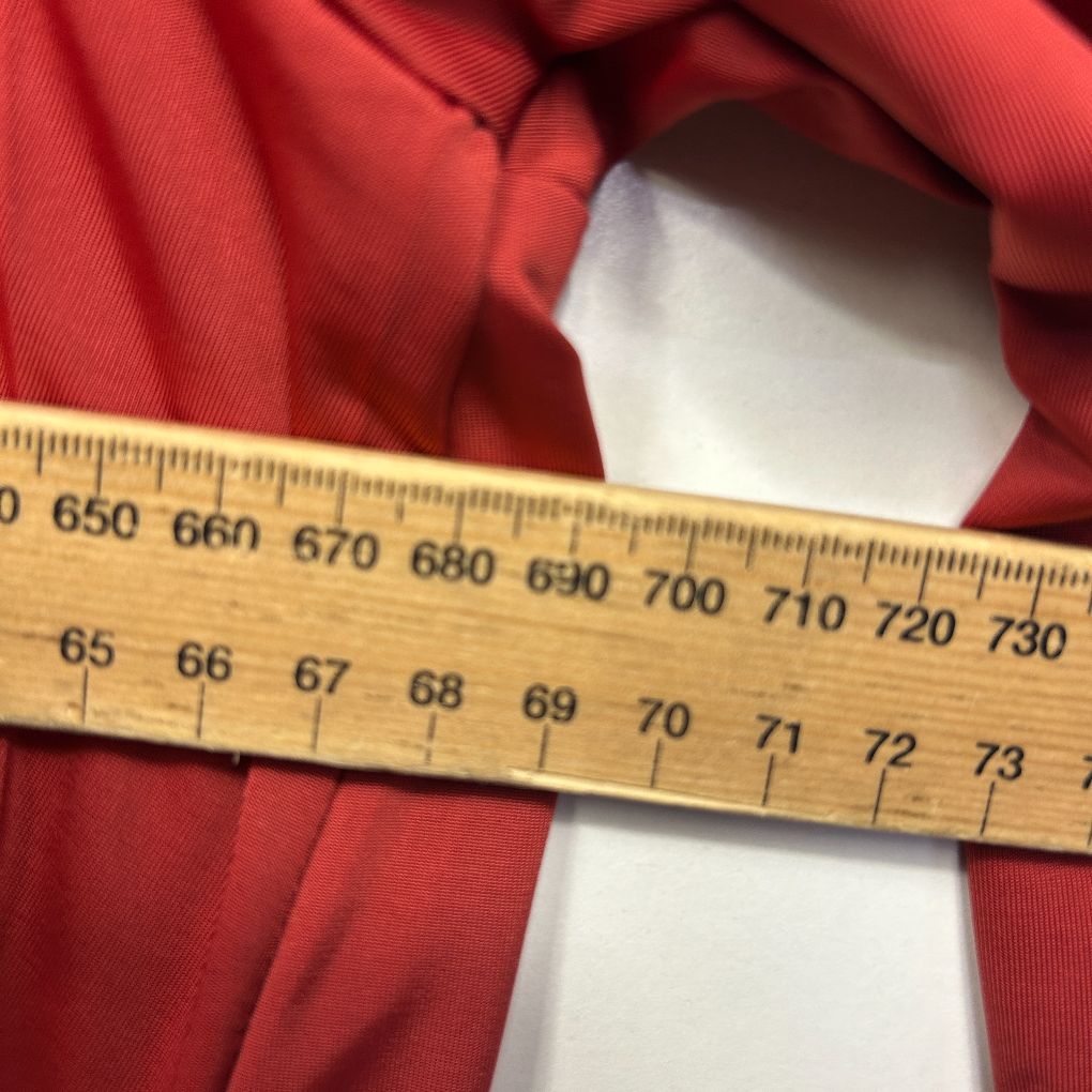 Red and white striped fabric with measuring tape detail view