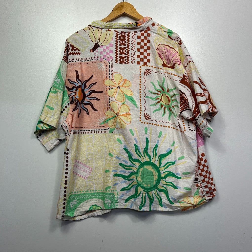 Multicolored patchwork tunic front view with sun and floral motifs
