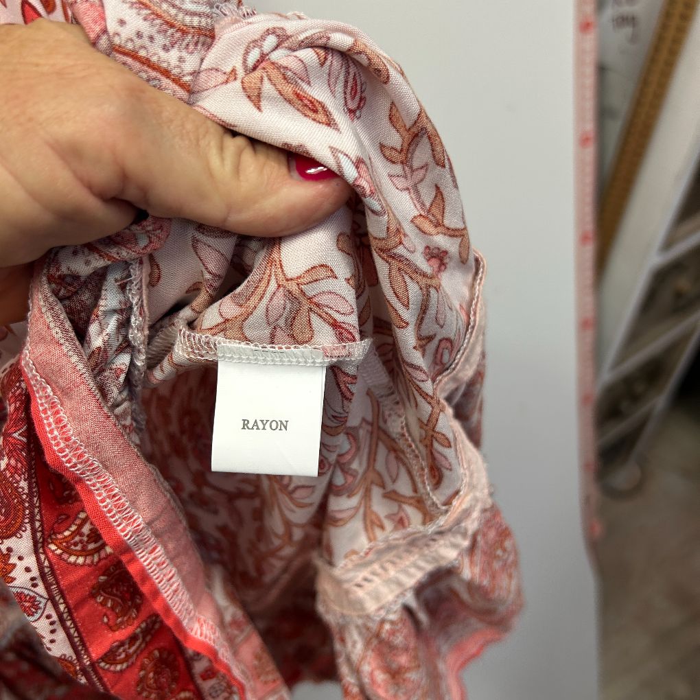 Red and white floral scarf detail view showing Rayon label