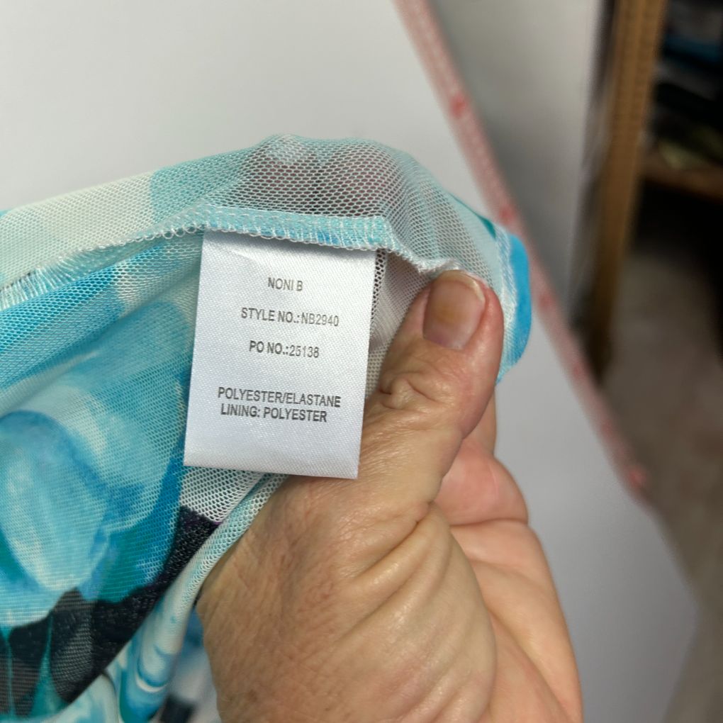 Turquoise blue garment label detail view