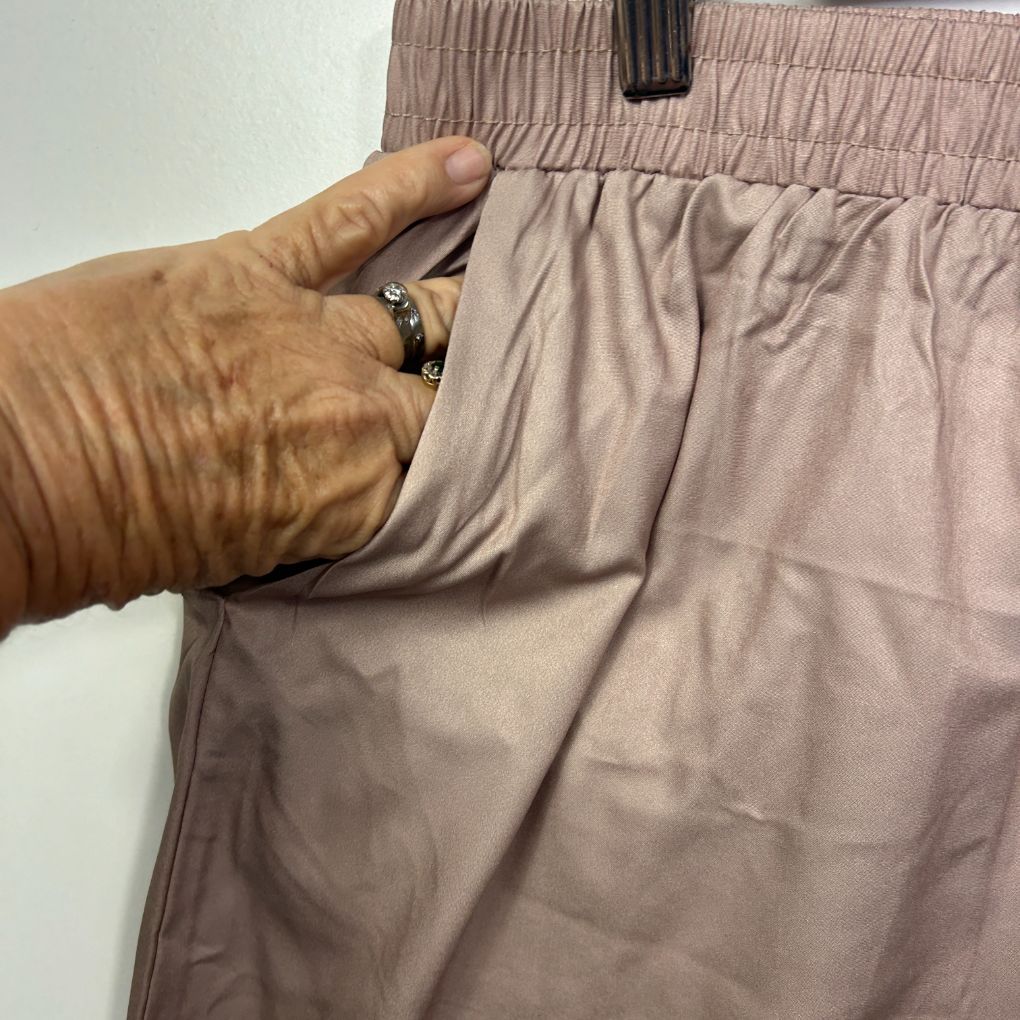 Beige pants detail view showing elastic waistband