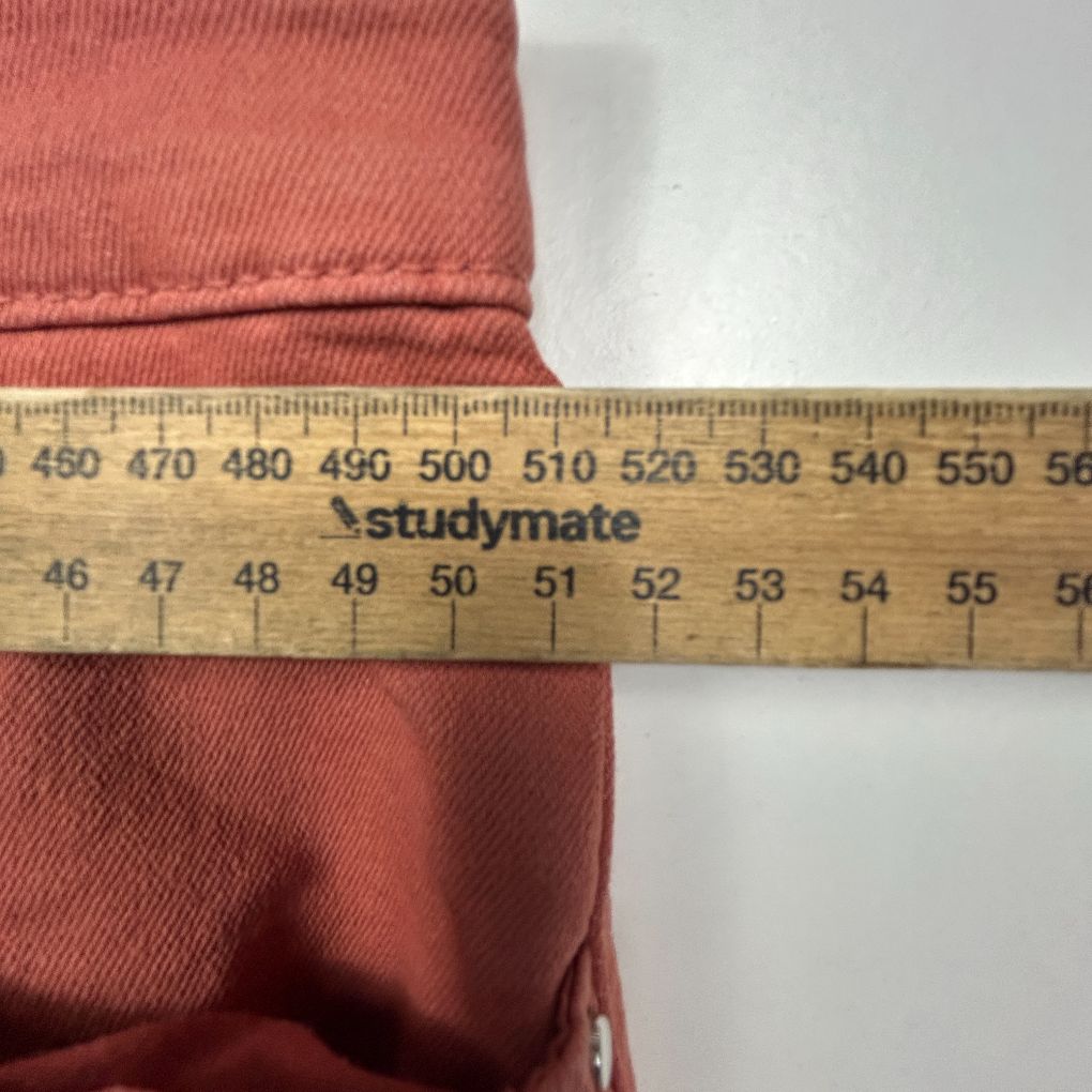 Rose pink garment with measurement tape detail view