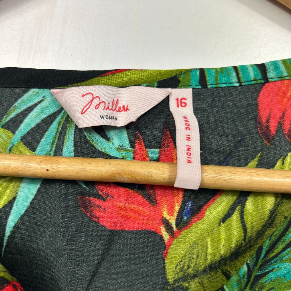 Floral fabric detail view with wooden handle