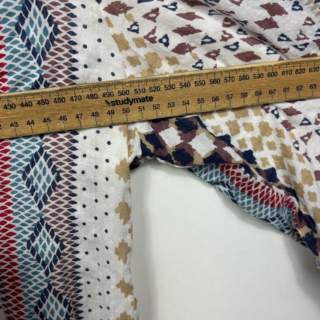 Multicolored patterned fabric detail view with measuring tape