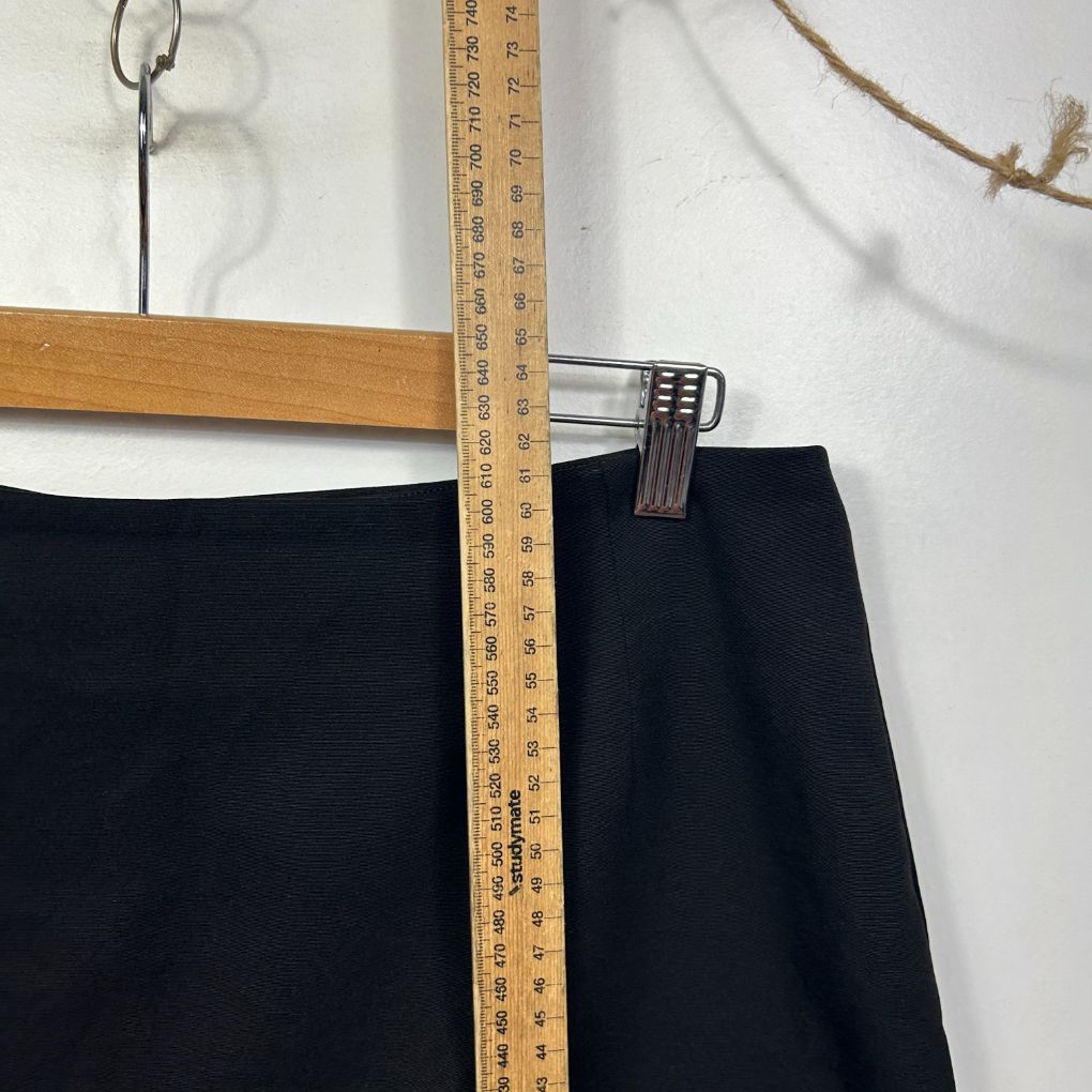 Black pants front view with measuring tape