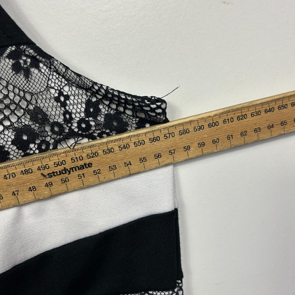 Black and white lace trim detail view with measuring tape