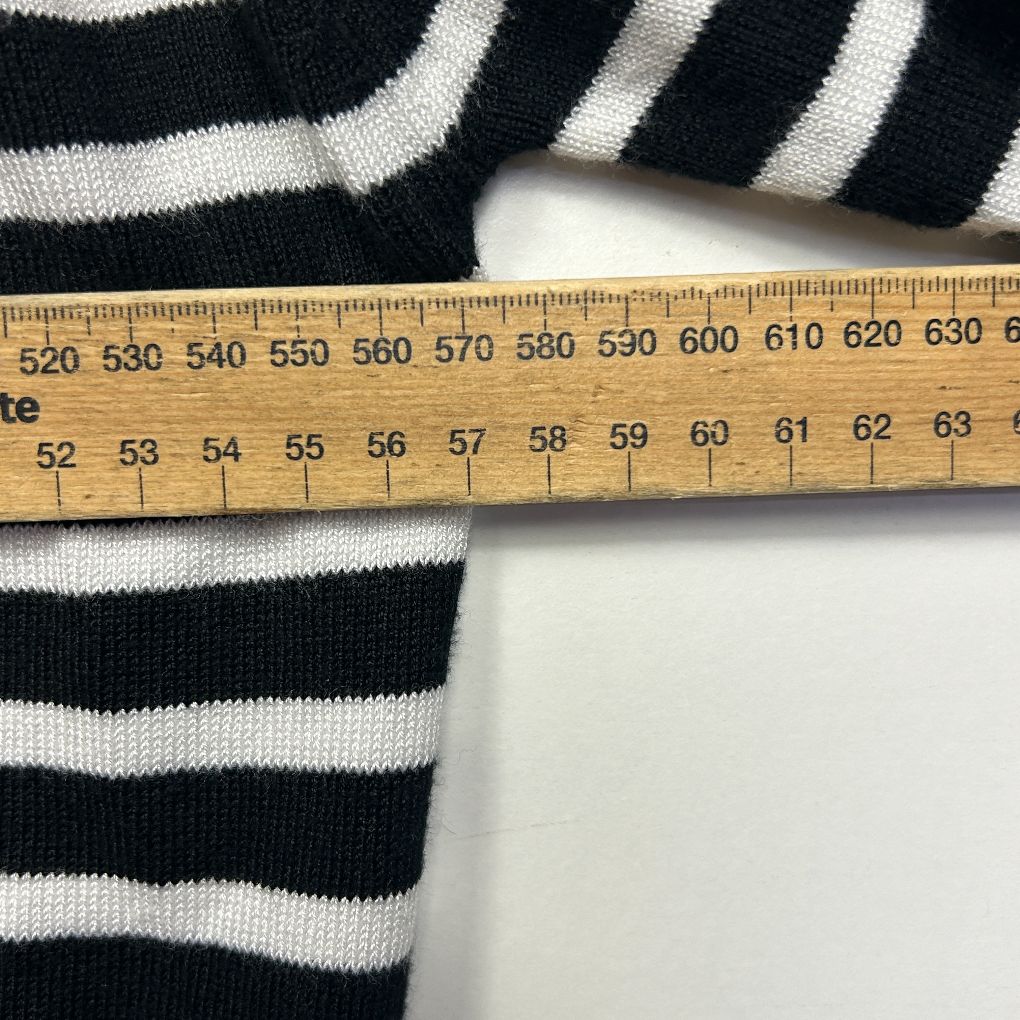Black and white striped knit fabric detail view with measuring tape