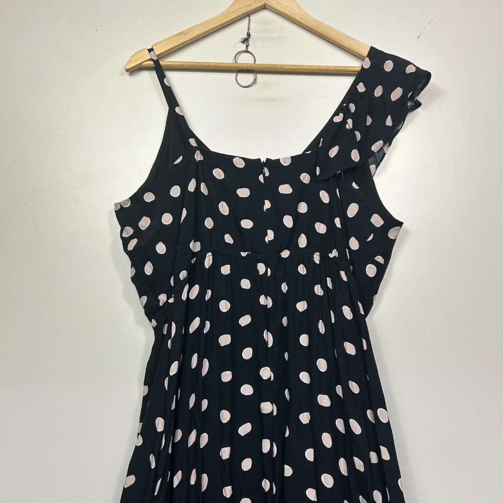 Navy sleeveless dress with white polka dot pattern front view