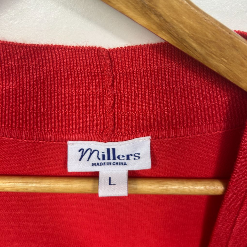 Red ribbed sweater label detail view