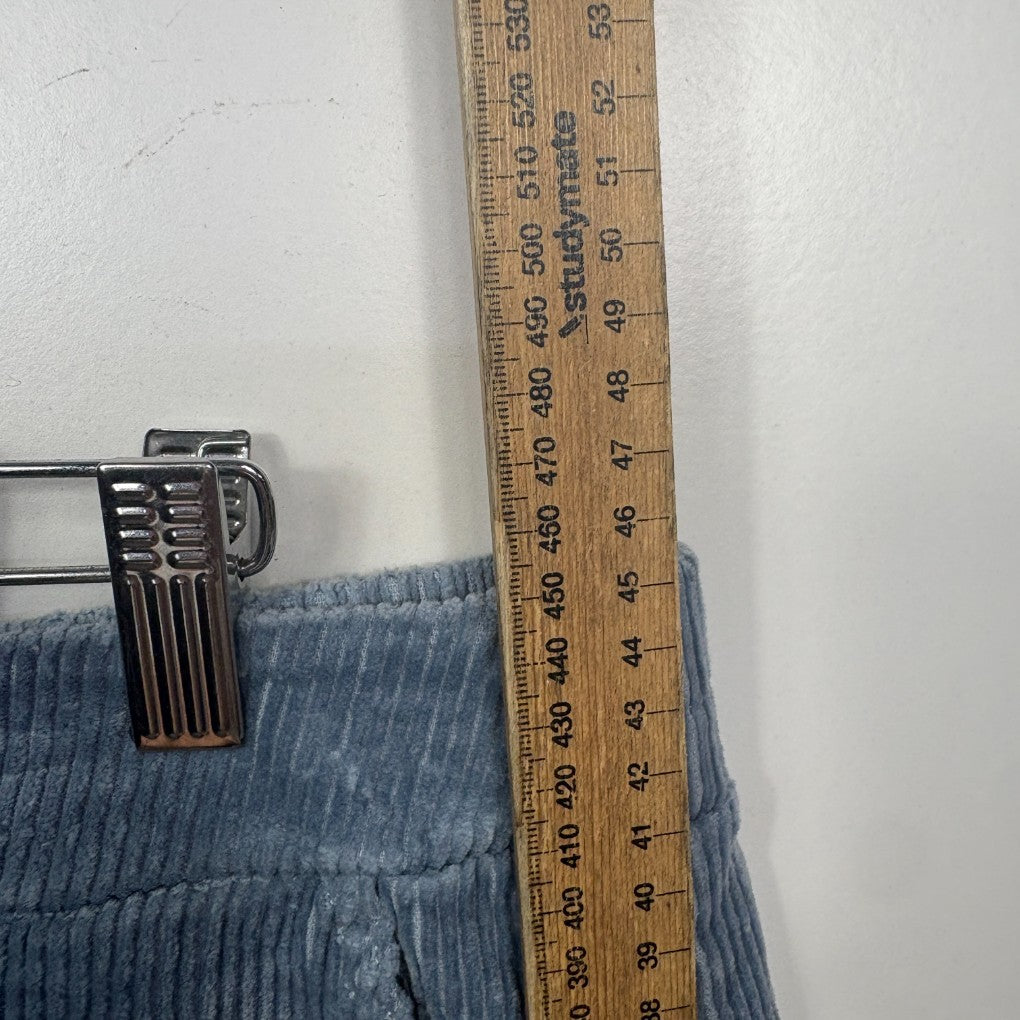 Blue ribbed fabric detail view with measuring tape