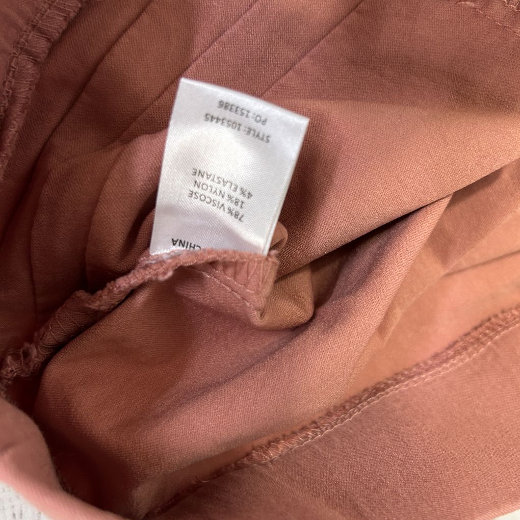 Rose brown garment detail view showing interior label