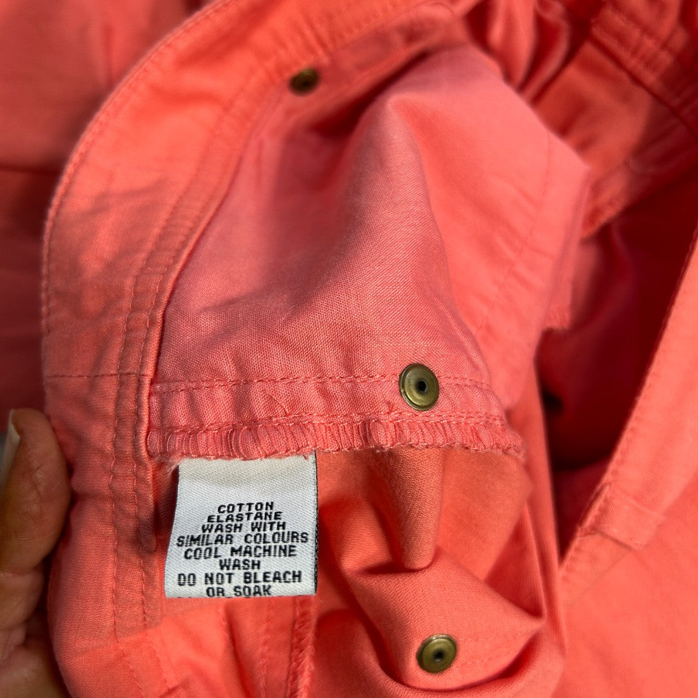 Coral jacket detail view showing care label and buttons