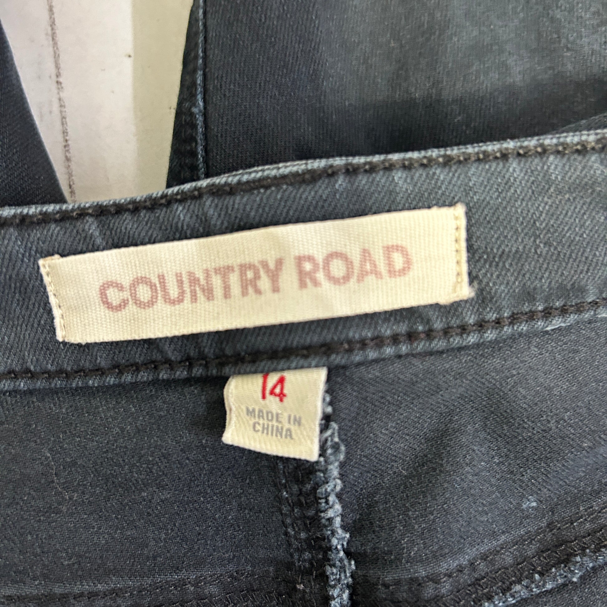 Dark grey denim jeans label detail view